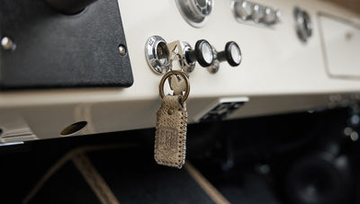 Close-up of leather keychain hanging from dashboard of Classic Ford Bronco