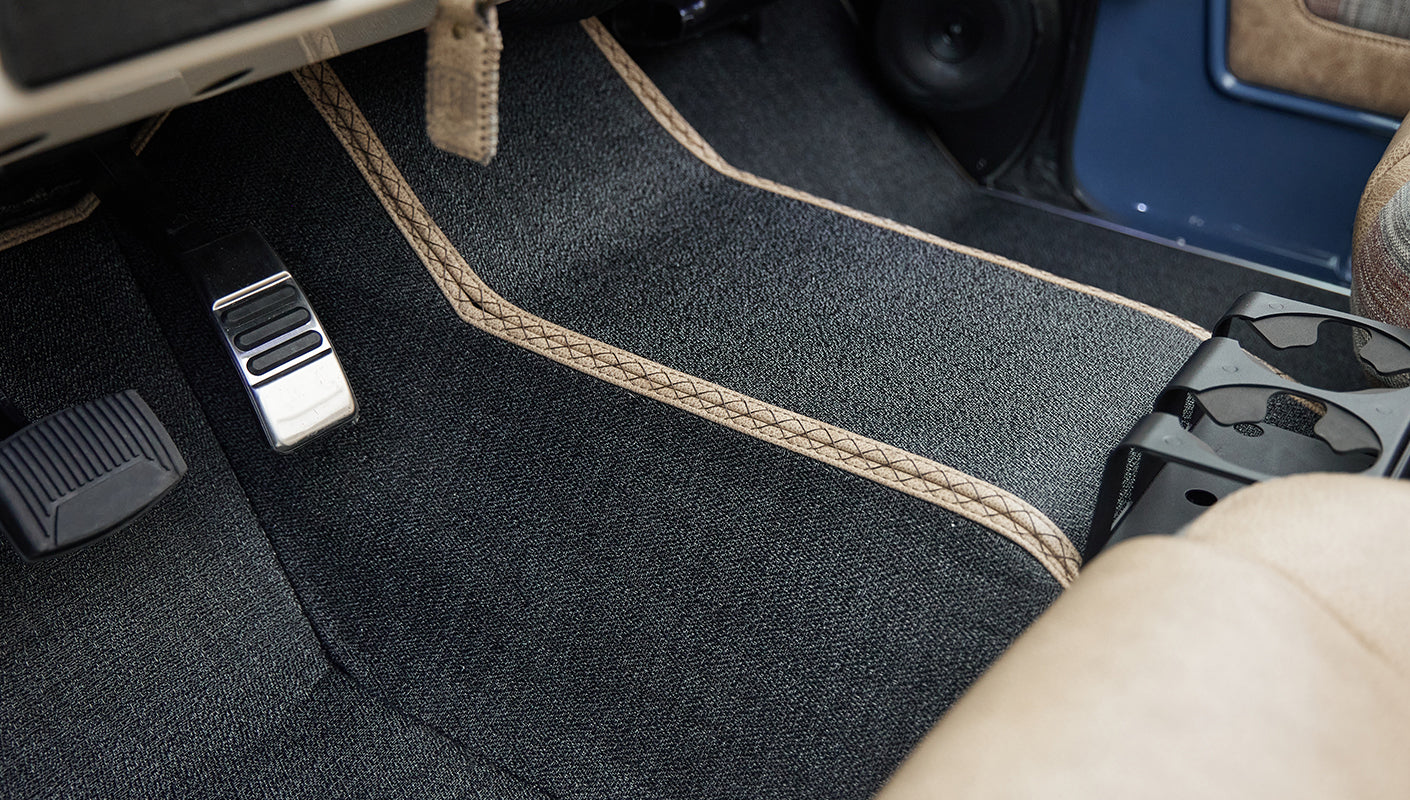 Close-up of Classic Ford Bronco front passenger floor area carpet and pedals