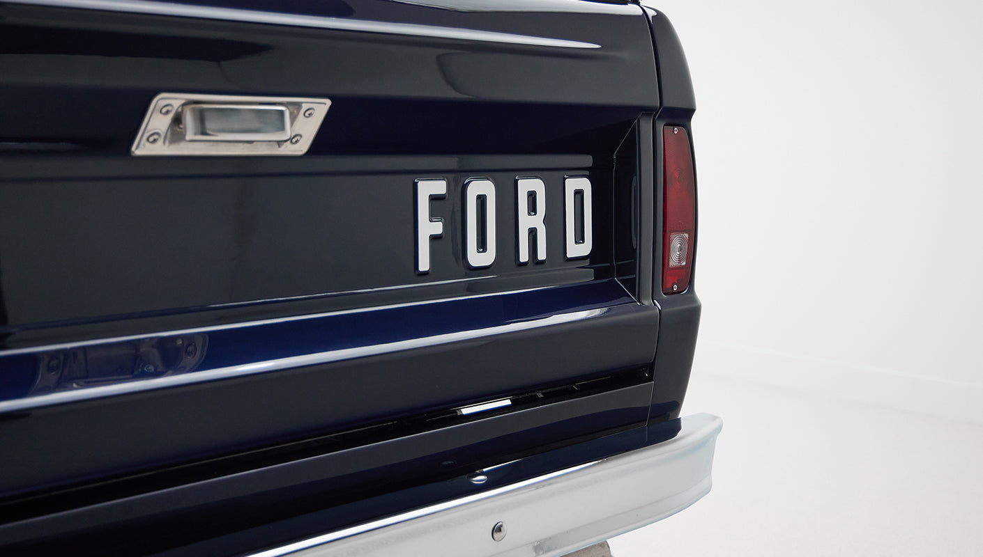 Close-up of Classic Ford Bronco rear tailgate with white FORD lettering and red taillight