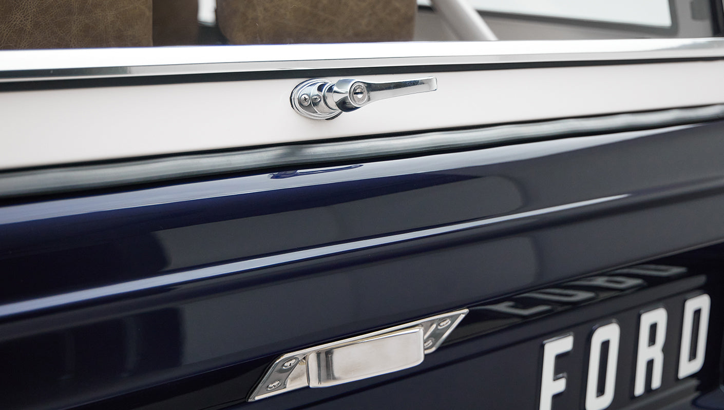 Close-up of Classic Ford Bronco rear with focus on chrome handle and FORD lettering