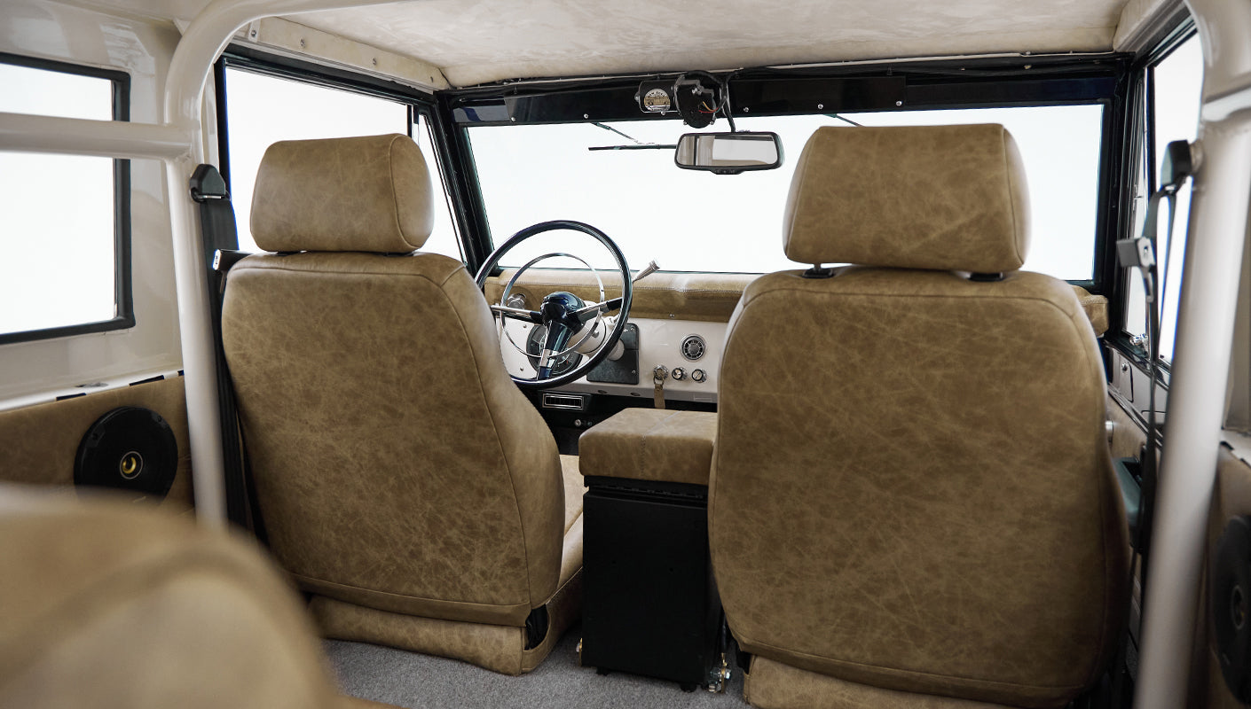 Interior front view of Classic Ford Bronco with tan seats and steering wheel