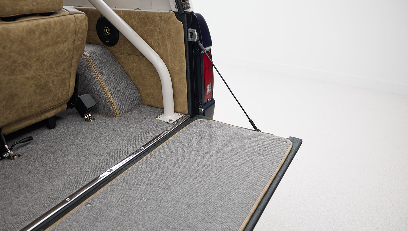 Rear tailgate carpeted interior section of Classic Ford Bronco with support props