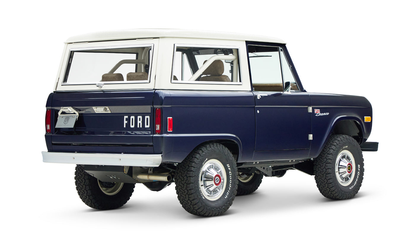 Classic Ford Bronco in sapphire blue with white hardtop, angled right rear view