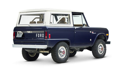 Classic Ford Bronco in sapphire blue with white hardtop, angled right rear view