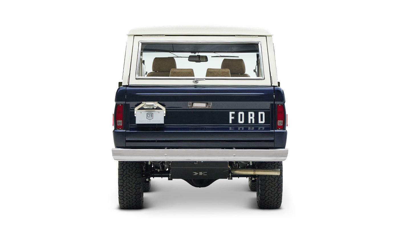 Rear view of classic Ford Bronco in sapphire blue with white hardtop