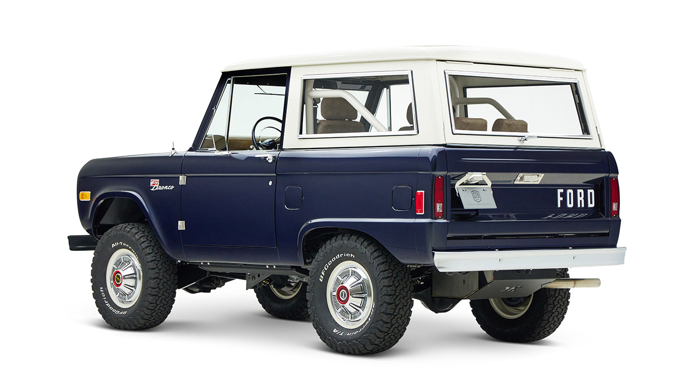 Classic Ford Bronco in sapphire blue with white hardtop, angled left rear view