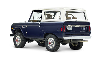 Classic Ford Bronco in sapphire blue with white hardtop, angled left rear view