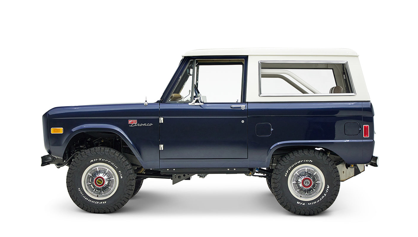 Classic Ford Bronco in sapphire blue with white hardtop, left side profile