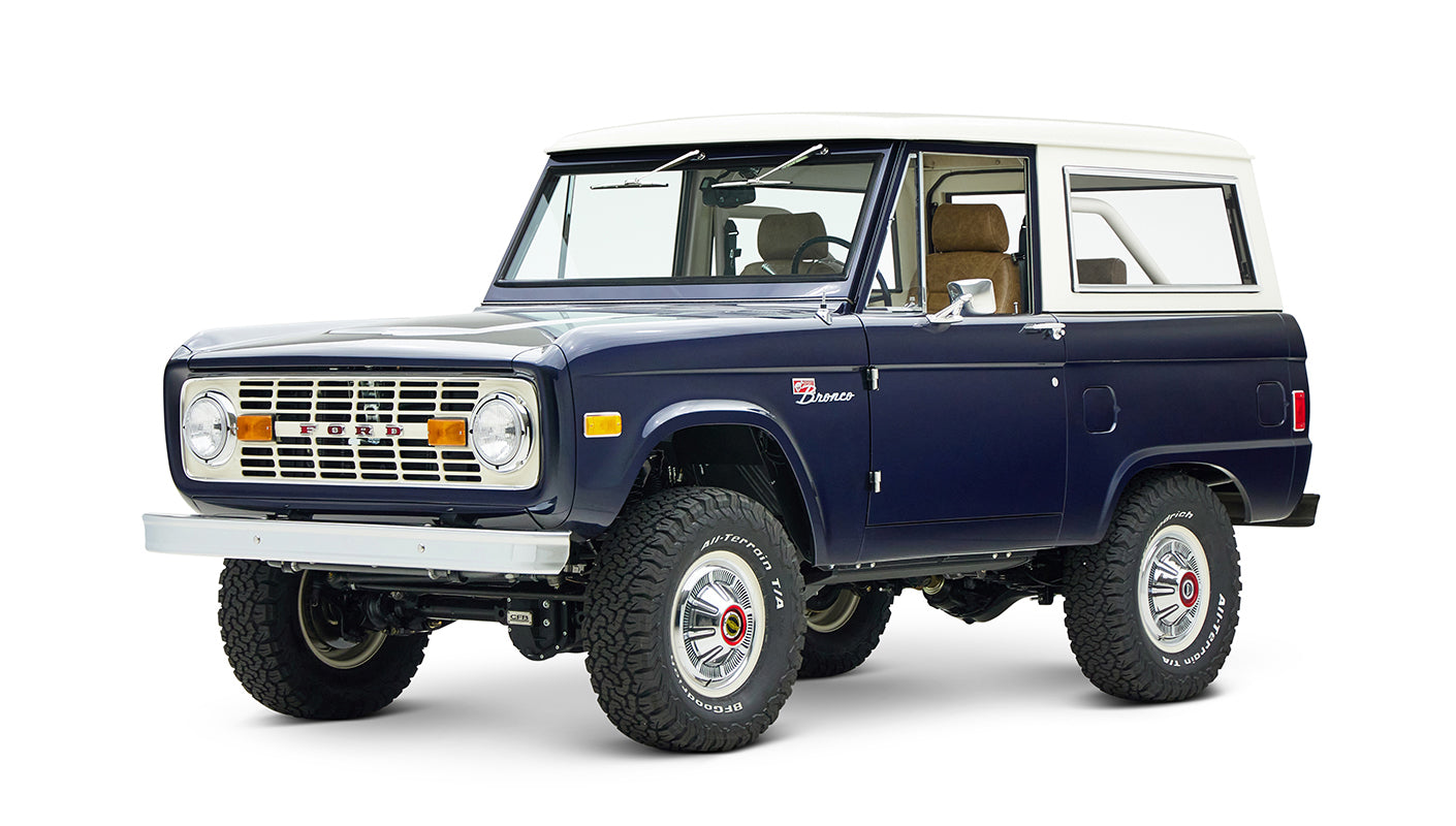Classic Ford Bronco in sapphire blue with white roof, angled right front view