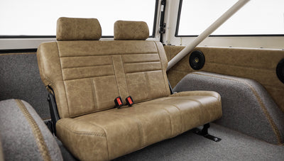 Rear seats of Classic Ford Bronco, showing tan leather upholstery and roll bars