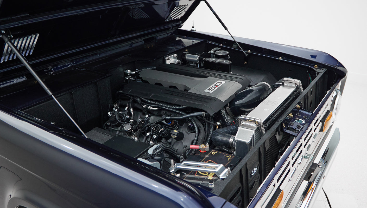 Engine bay of Classic Ford Bronco displaying a 5.0 engine and clean engine compartment