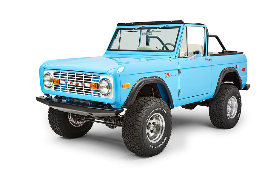 Front three-quarter view of bright blue Classic Ford Bronco highlighting front grille and headlights.