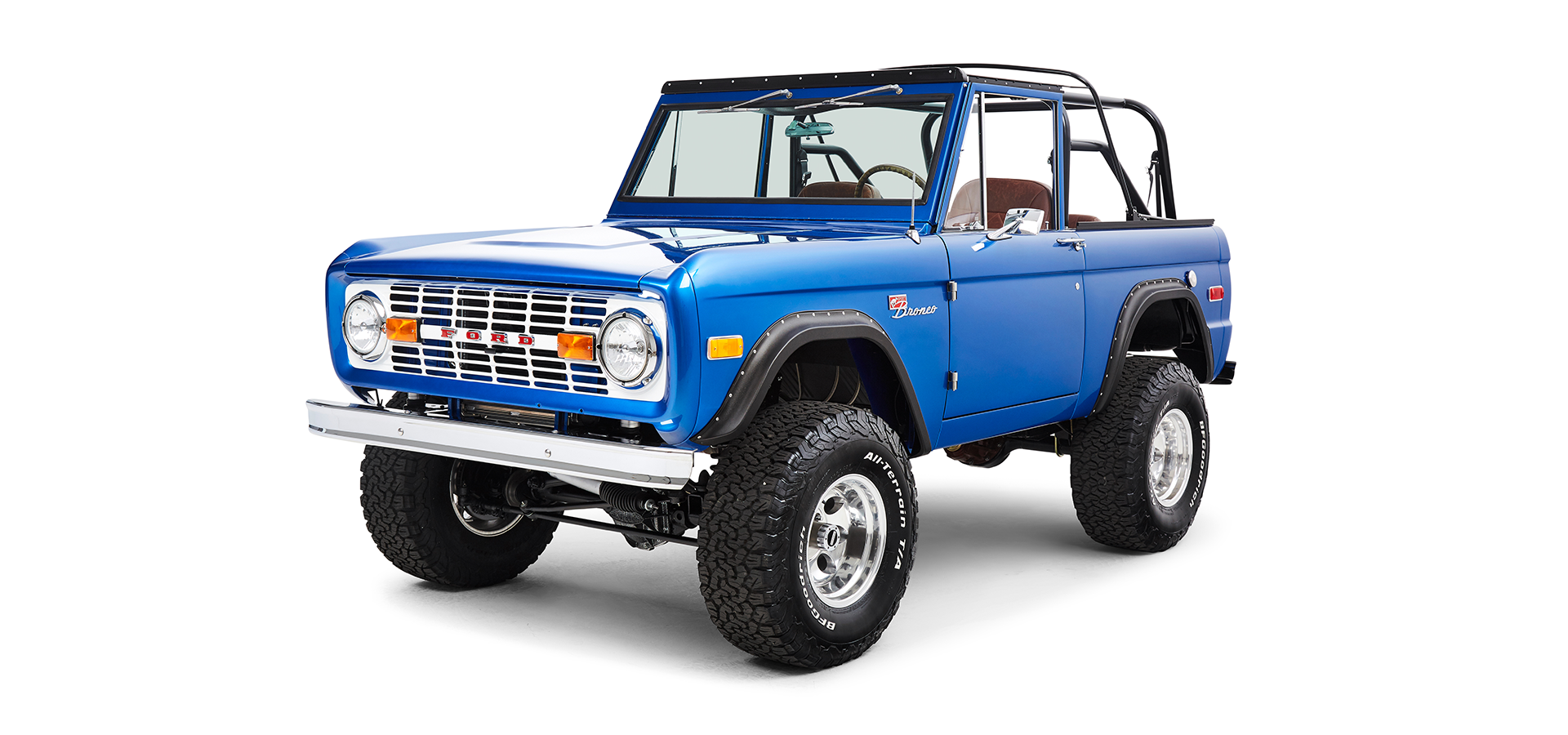 Classic blue Ford Bronco angled view from front driver side showing grill, headlights, and tires