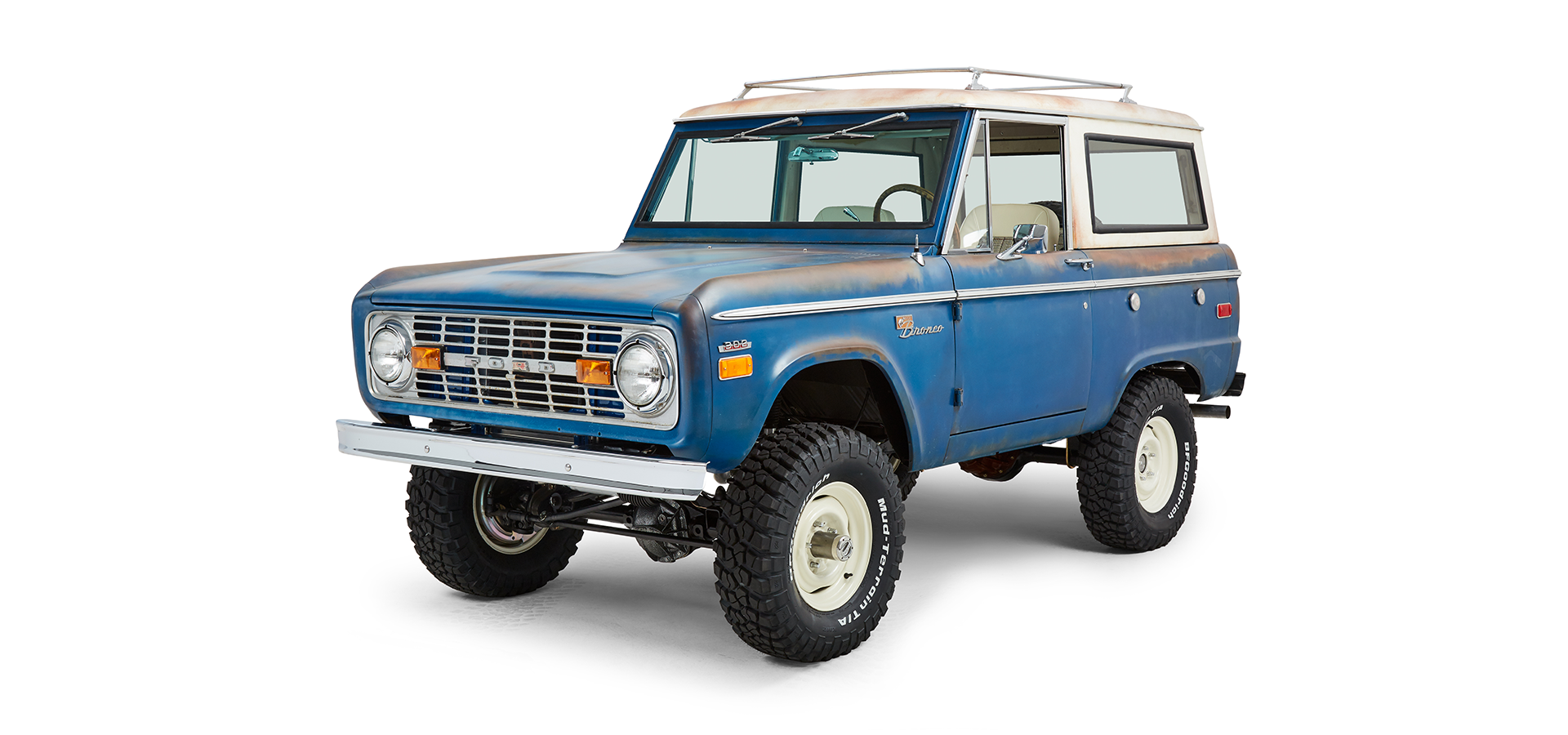 Classic Ford Bronco front driver side angled view with rust accents and off-road tires