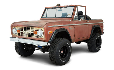 Front driver angle view of a red Classic Ford Bronco with lift suspension and black wheels
