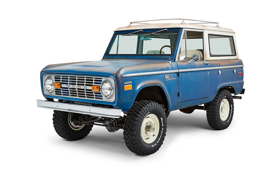 Classic Ford Bronco front driver side angled view showing grille, headlights, and bumper