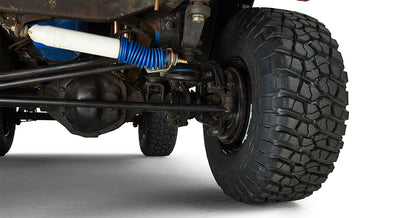 Close-up of off-road tire and front driver's suspension components on Classic Ford Bronco.