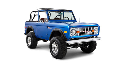 Front angled view of blue Classic Ford Bronco showing passenger side and roll cage