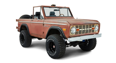 Classic Ford Bronco angled front passenger side in faded red rusty finish