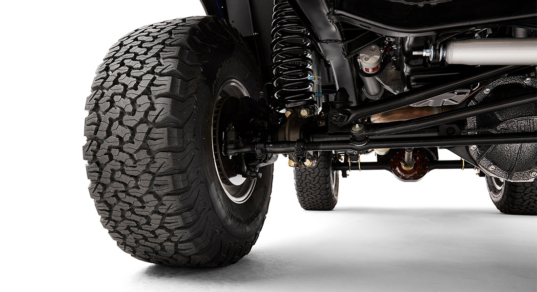 Close-up of Classic Ford Bronco front passenger side suspension and tire