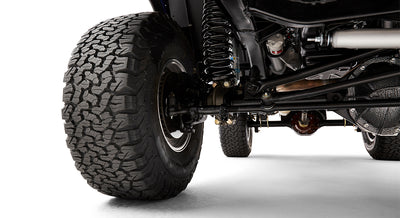 Close-up of Classic Ford Bronco front passenger side suspension and tire