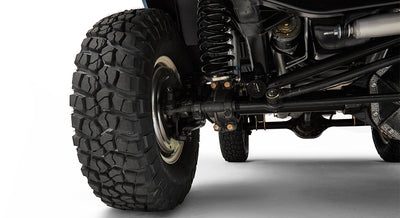 Close-up of front passenger side suspension and tire of Classic Ford Bronco