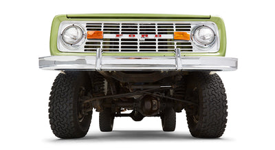 Undercarriage view of green Classic Ford Bronco front suspension and tires