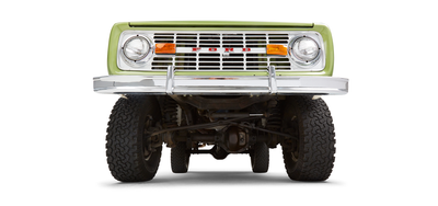 Close-up undercarriage view of green Classic Ford Bronco front axle and suspension