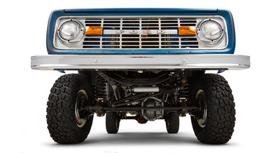 Undercarriage view showing front axle, suspension, and tires of Classic Ford Bronco