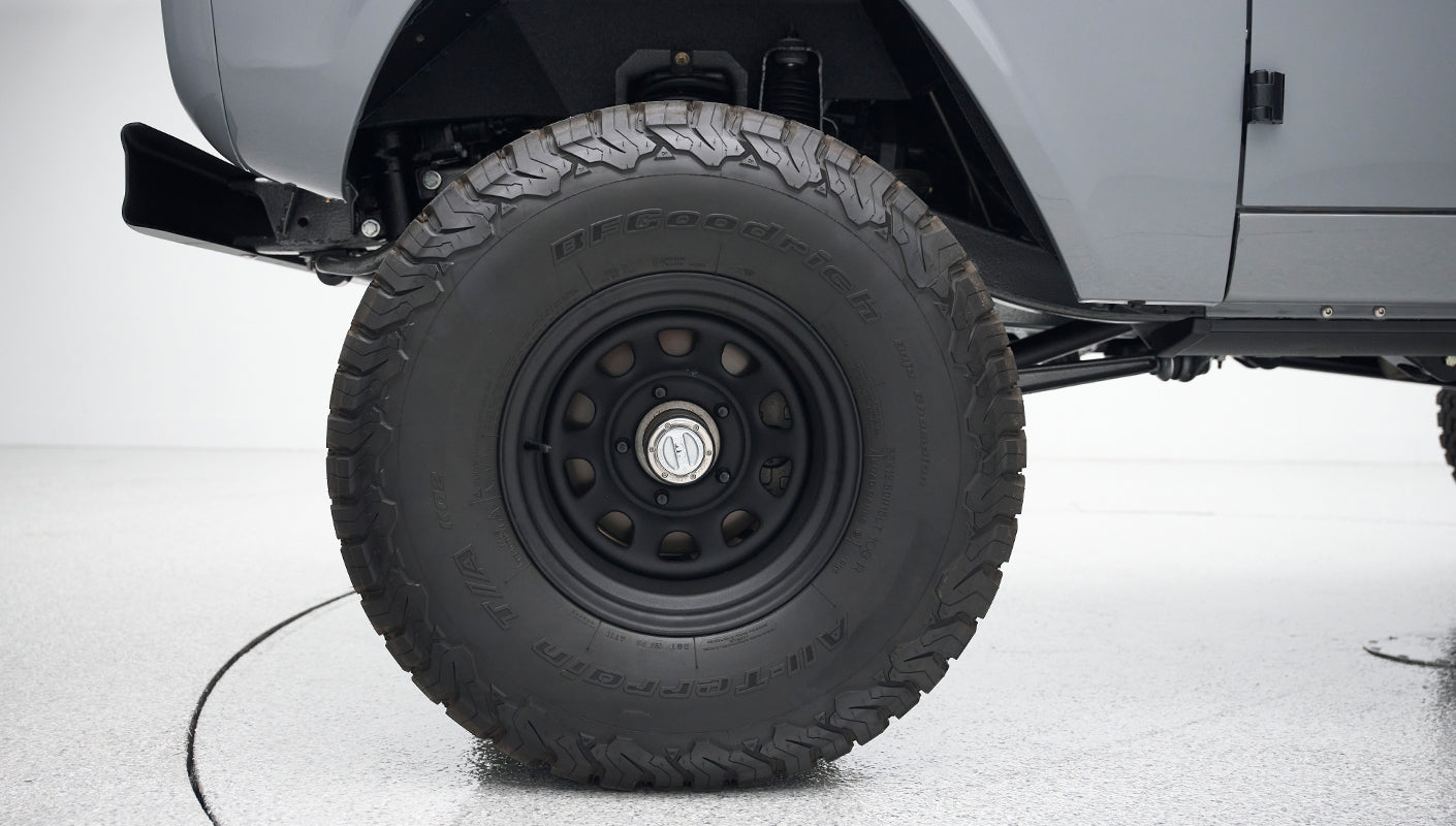 Close-up of black off-road tire with BFGoodrich lettering under Classic Ford Bronco