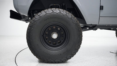 Close-up of black off-road tire with BFGoodrich lettering under Classic Ford Bronco
