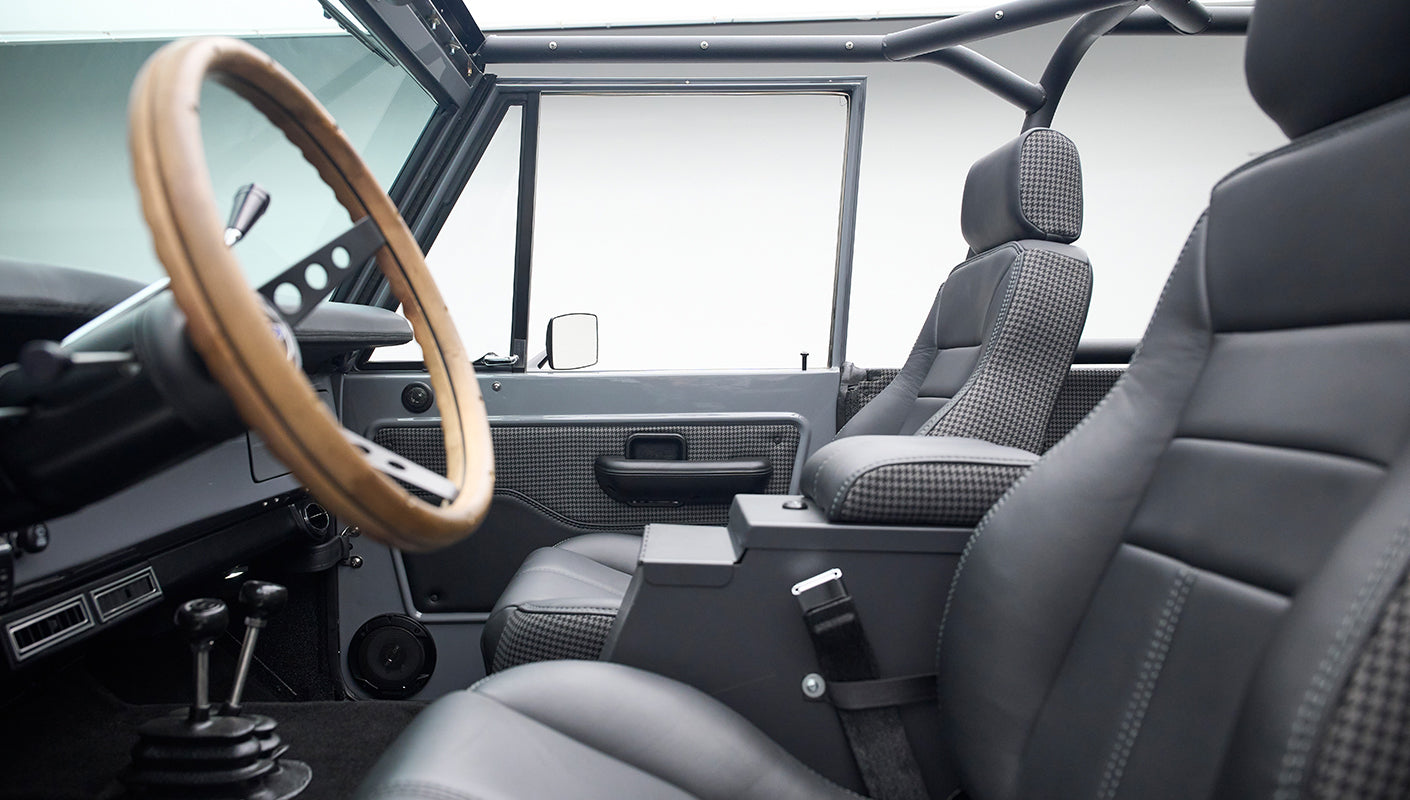 Interior front seats of Classic Ford Bronco with black leather and gray houndstooth upholstery