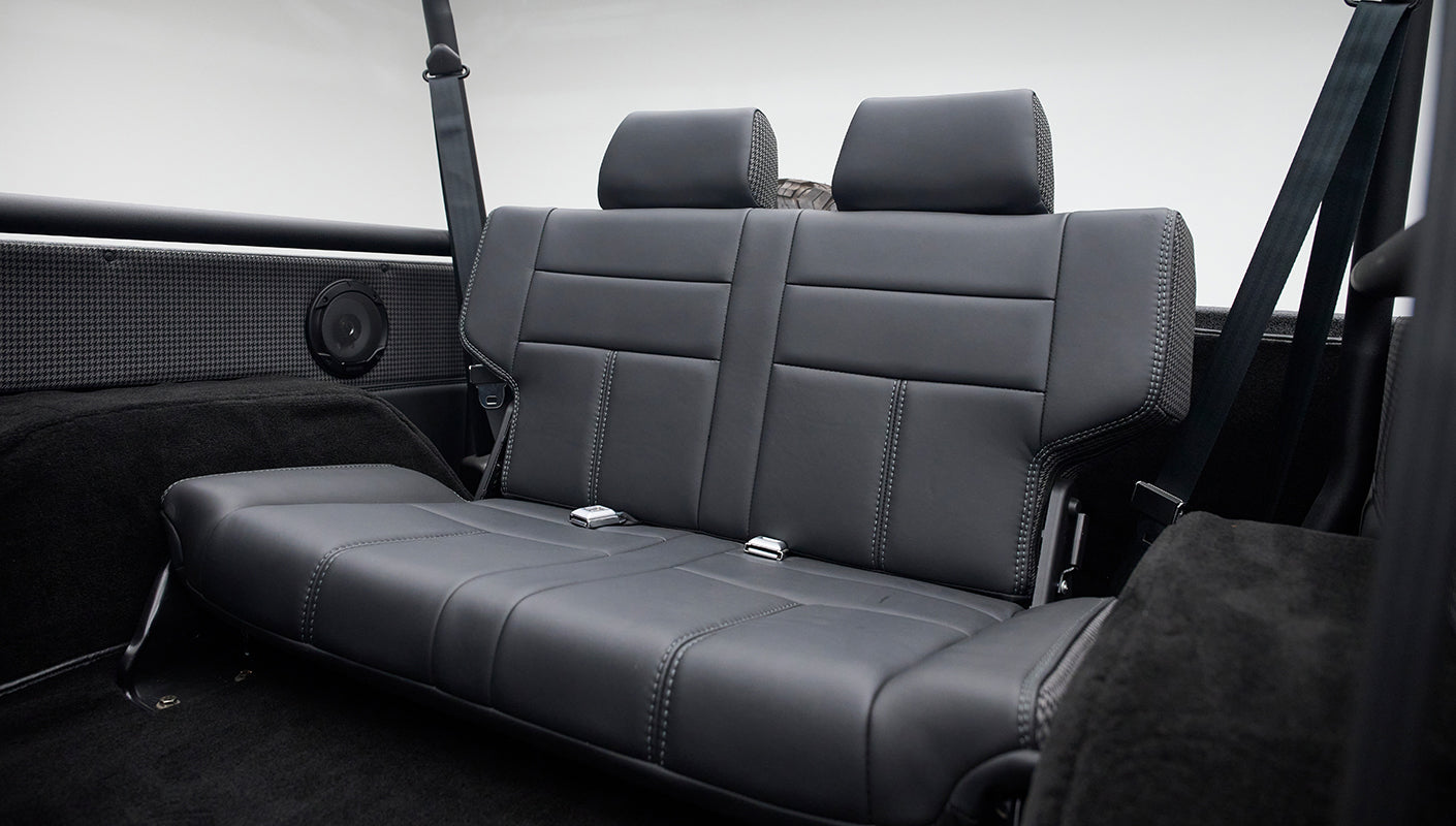 Rear black leather seat with two headrests and seat belts inside Classic Ford Bronco