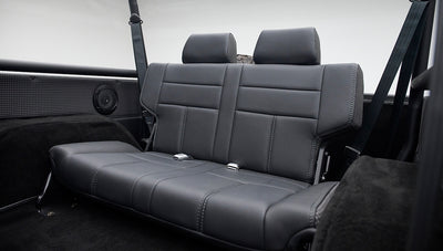 Rear black leather seat with two headrests and seat belts inside Classic Ford Bronco