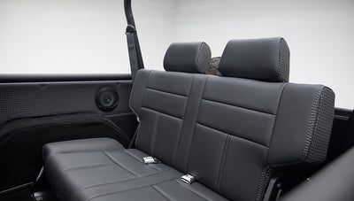 Classic Ford Bronco rear black leather seat with two headrests and surrounding roll cage bars