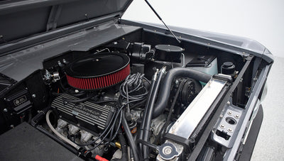 Engine bay of Classic Ford Bronco with visible air filter and components