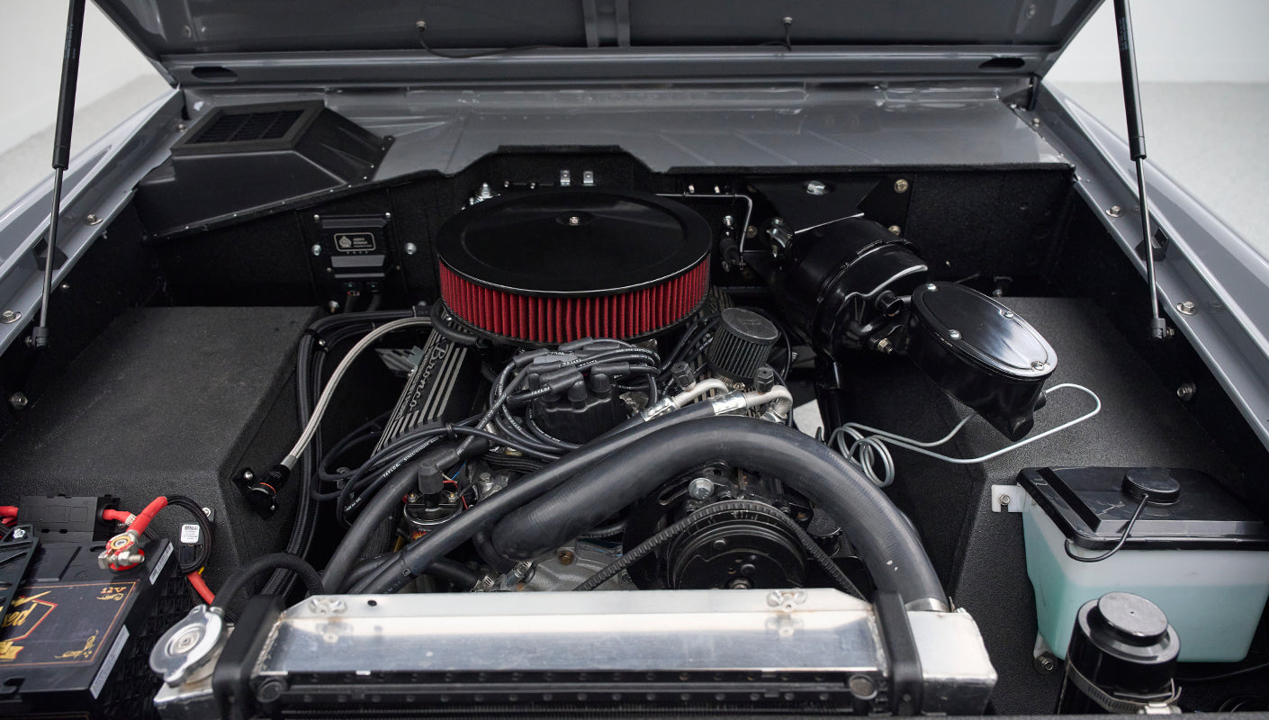 Another angle of Classic Ford Bronco engine bay showing battery and radiator