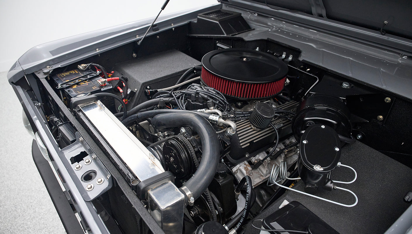 Engine bay close-up showing air filter and other engine details of Classic Ford Bronco