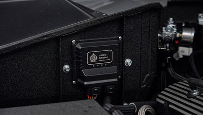 Black AS2012 Killshot automotive component mounted on textured black panel with wiring.