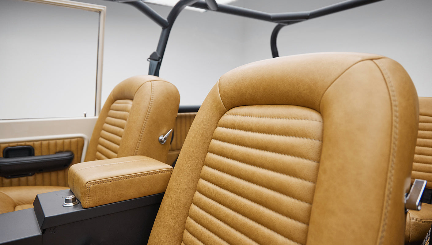 Close-up of tan leather seats and black center console inside Classic Ford Bronco