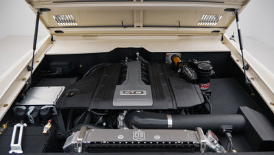 Engine bay showing 5.0 engine cover and cooling system components