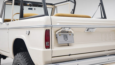 Rear corner of Classic Ford Bronco showing tailgate, license plate, and rear tire