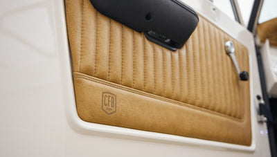 Close-up of tan leather Classic Ford Bronco interior door panel with CFB Series logo