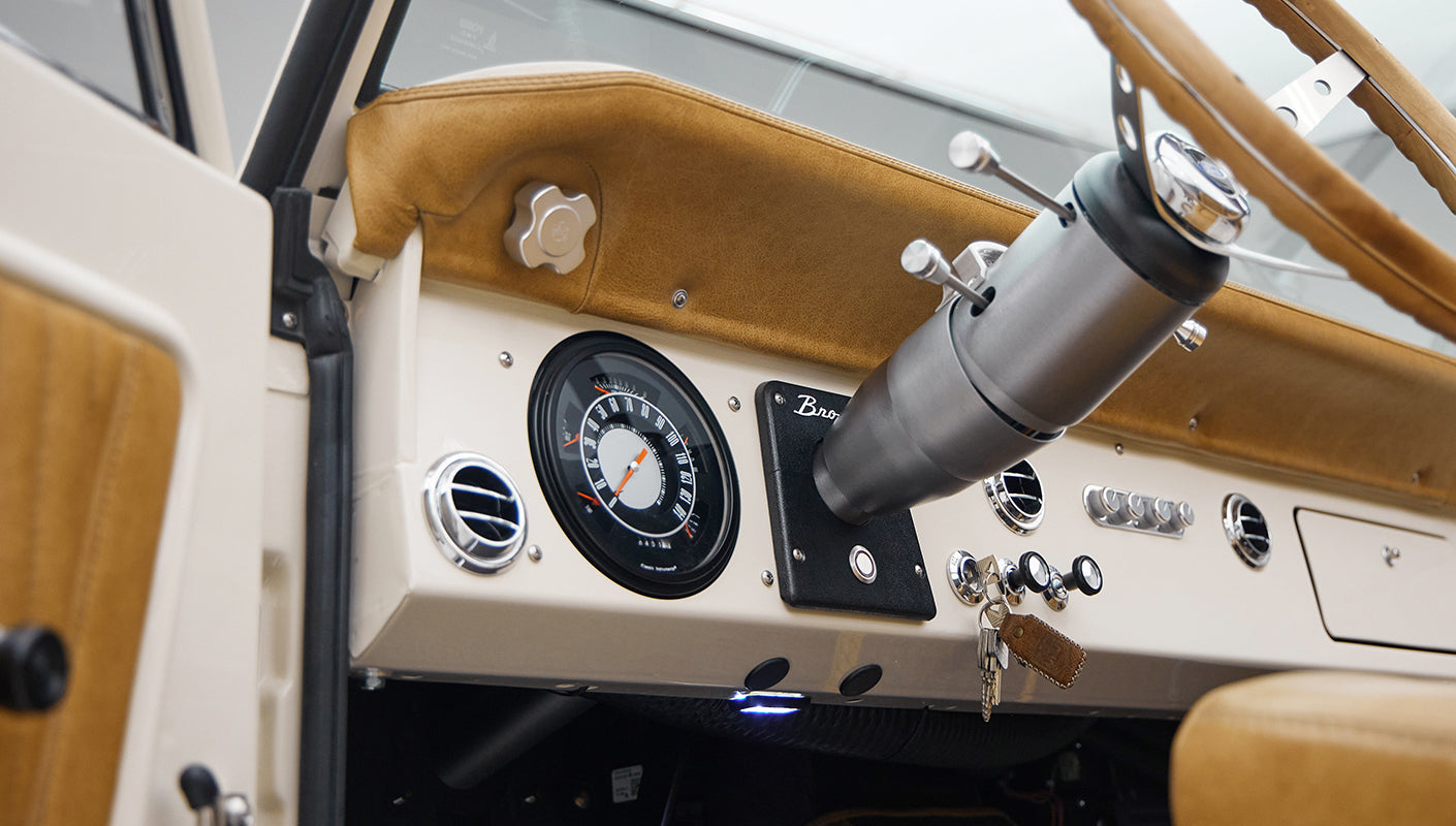 Classic Ford Bronco dashboard featuring steering column, speedometer, and air vents