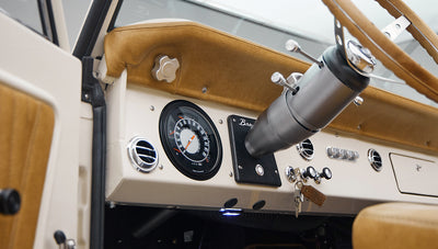 Classic Ford Bronco dashboard featuring steering column, speedometer, and air vents