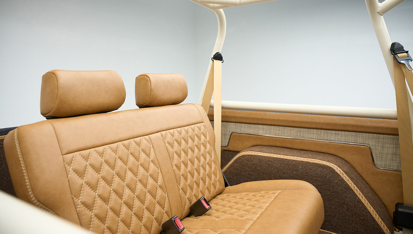 Rear bench seat and door panel with detailed stitching in classic Ford Bronco interior