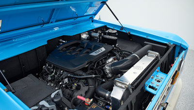 Open hood revealing 5.0 engine and components of Classic Ford Bronco