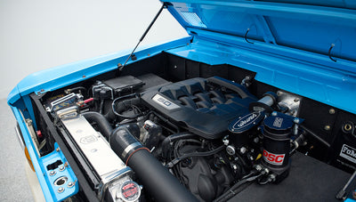 Open hood showing clean engine bay and 5.0 engine in Classic Ford Bronco