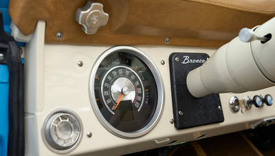 Speedometer and dashboard area of Classic Ford Bronco in cream and black color
