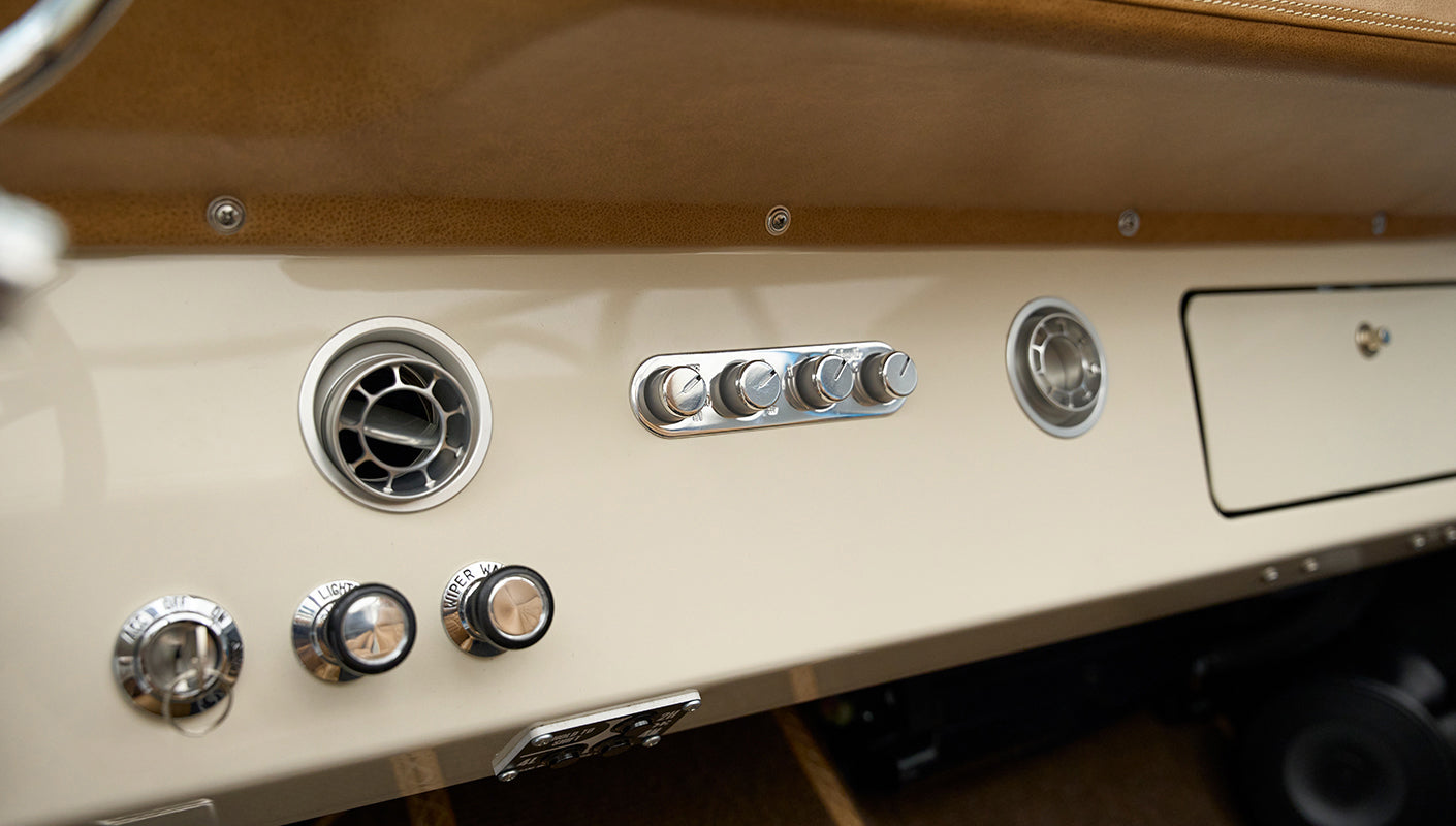Dashboard controls and air vents in Classic Ford Bronco with cream finish